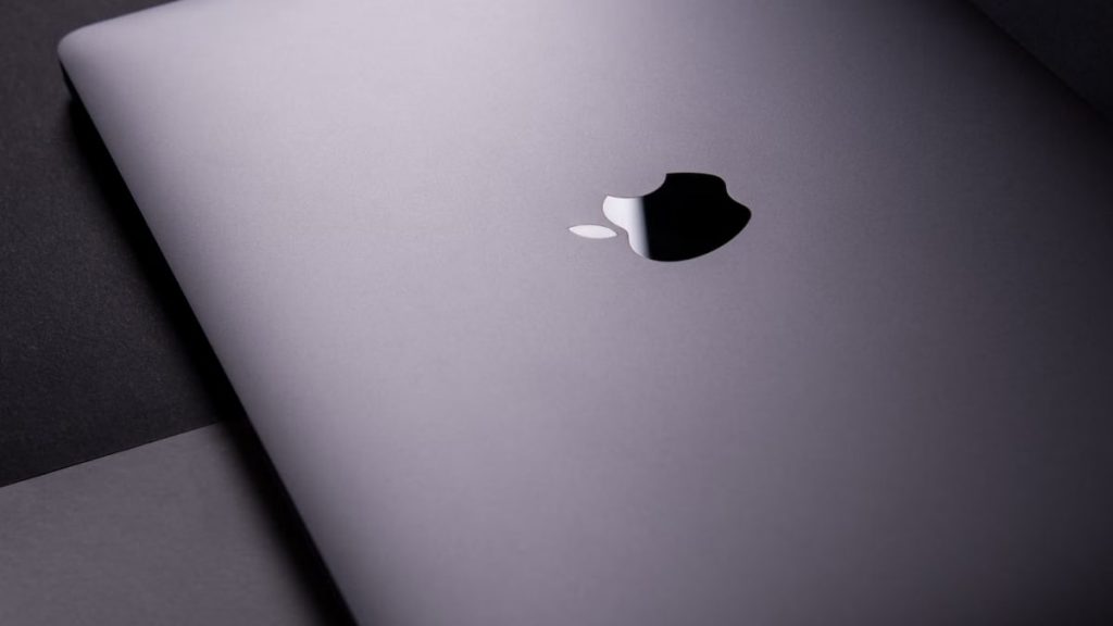 Close-up of a sleek, modern laptop featuring a minimalist design on a dark surface.